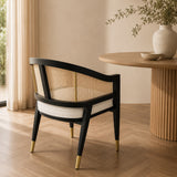 Levanto Dining Chair in black wood with natural rattan backrest and cream upholstered seat in a luxury dining interior.