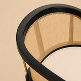 Levanto Dining Chair in black wood with natural rattan backrest and cream upholstered seat in a luxury dining interior.