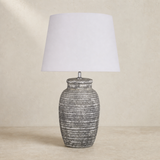 Addie Ceramic Lamp on warm beige plaster and limestone background