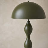 Close-up of olive green floor lamp dome shade and satin sculptural stem finish