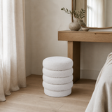 Ambasciata ivory bouclé ottoman styled in a European minimalist bedroom
