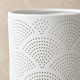 Close-up of Arco white porcelain lamp perforated fan pattern and glazed rim