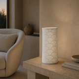 Arco Porcelain Table Lamp White glowing softly in a Mediterranean minimalist reading nook