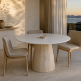 Arezzo round marble and timber dining table in a coastal apartment at evening