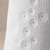 Ari lamp close-up of the embossed white porcelain and perforations
