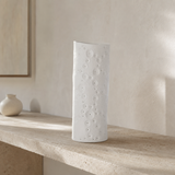 Ari white porcelain lamp on a travertine console in a Mediterranean interior