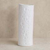 Ari white porcelain lamp in a warm beige studio