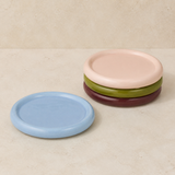 Arli four-piece glazed ceramic set in a warm beige studio