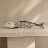 Arli decorative ceramic fish on a travertine console