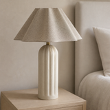 Aspen Resin Lamp Ivory from an alternate angle in a minimalist bedroom
