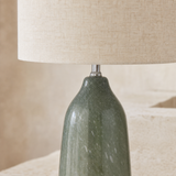 Bali Rattan Lamp close-up of the sage green mottled base, silver fitting and ivory linen shade