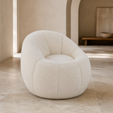 Bambolina Teddy Boucle Armchair from an alternate angle in a European gallery interior