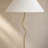 Becker Floor Lamp close-up of brushed brass curved stem and white shade