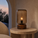 Belize lamp glowing at dusk in a refined Mediterranean reading corner
