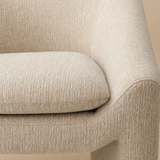 Close-up of the Bergamo armchair cream woven upholstery, cushion and curved arm