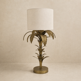 Bermuda antique brass palm table lamp in a warm beige Elara studio