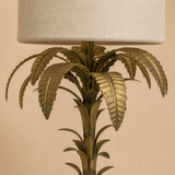 Close-up of the Bermuda lamp antique brass palm fronds, trunk and linen shade