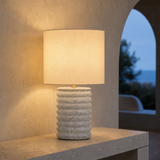 Bern Blue ceramic table lamp glowing at blue hour in a Mediterranean interior