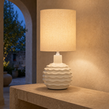 Bern Green ceramic table lamp glowing at blue hour in a Mediterranean interior