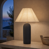 Bern Pink ceramic table lamp glowing at blue hour in a Mediterranean interior