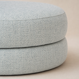 Close-up of the woven upholstery and two-tier construction of the Bianca Round Boucle Ottoman