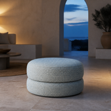 Bianca Round Boucle Ottoman in a Mediterranean lounge at blue hour