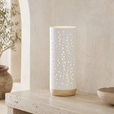 Bolla Porcelain and Wood Lamp glowing on a Mediterranean console