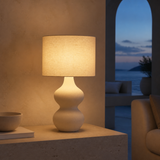 Bondi Rattan Lamp illuminated in a Mediterranean lounge at blue hour