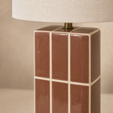 Close-up of Boyd lamp glossy brown ceramic cream grid brass and linen finish