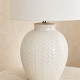 Close-up of Braid lamp glossy ivory ceramic woven relief and linen shade