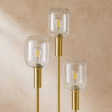 Close-up of Bruno floor lamp clear glass shades and brushed brass fittings