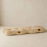 Burley pale timber live-edge piece in a warm beige studio