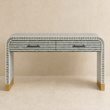 Camano console table with tessellated stripes in a warm beige studio