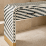 Close-up of Camano console tessellated finish, black handle and gold foot