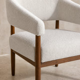 Close-up of Campania chair ivory upholstery and walnut timber joinery