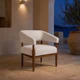 Campania ivory chair in a Mediterranean lounge at blue hour