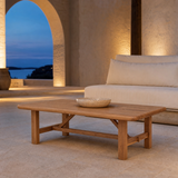 Cortona elm coffee table on a Mediterranean terrace at blue hour