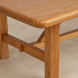 Close-up of Cortona elm tabletop grain and traditional peg joinery