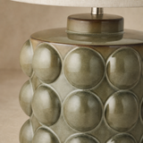 Close-up of Drift lamp olive resin bubble reliefs and glazed finish