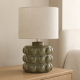 Drift olive resin table lamp in a refined European bedroom
