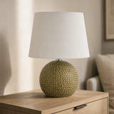 Drift Medium olive resin globe lamp in a refined European bedroom