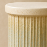 Close-up of Duca pedestal porous ivory top, fluting and celadon patina