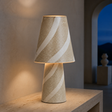 Faro Ceramic Table Lamp Ivory illuminated in a European interior at blue hour