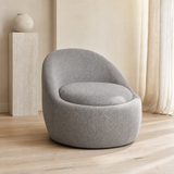 Firenze Curved Boucle Armchair in a minimalist European reading corner