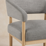 Hyatt chair close-up of grey woven upholstery, seams and light oak joinery