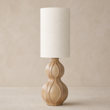 Koda Rattan Lamp in a warm beige studio setting
