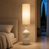Lido Resin Floor Lamp Natural glowing in a Mediterranean bedroom at blue hour