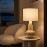 Lindi Ceramic Lamp glowing in a European coastal reading corner at blue hour