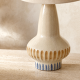 Close-up of Lindi Ceramic Lamp cream glaze, amber relief and blue brushwork