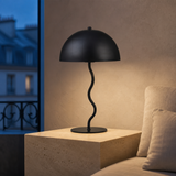 Madison black metal table lamp in a refined blue-hour European reading nook